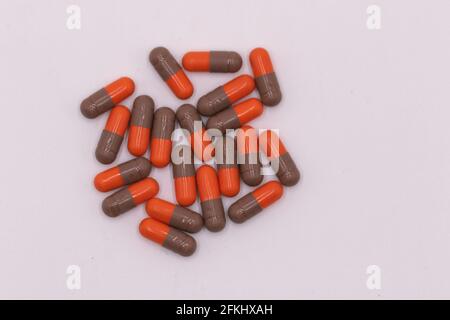 Selective focus macro image of Red and black color coated capsules with white background Stock Photo