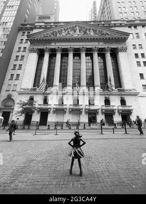 Fearless Girl bronze statue in the financial district in lower Manhattan area of New York City, NY, USA Stock Photo