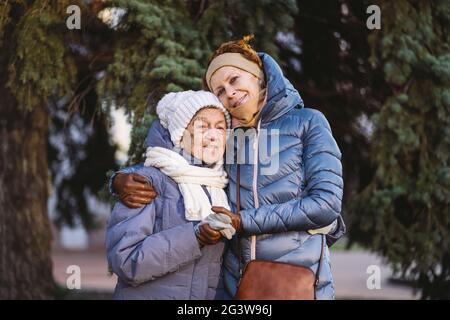 Couple of Caucasian mature woman and senior female are happy to spend time on Christmas and New Year holidays together, smiling Stock Photo