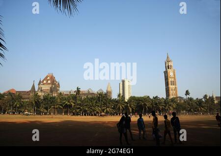 Young  boys playing cricket in Oval Maidan Attractions in Mumbai front of the Bombay University and High Court  situated just south of Churchgate Stock Photo