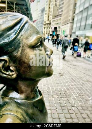 Fearless Girl bronze statue in the financial district in lower Manhattan area of New York City, NY, USA Stock Photo