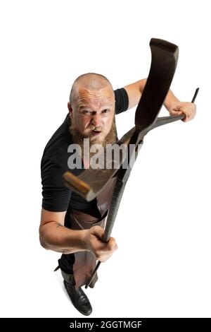 High angle view of bearded bald man, blacksmith wearing leather apron or uniform isolated on white studio background. Concept of labor, retro Stock Photo