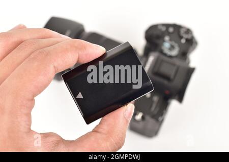 Camera Battery In Hand, Lithium ion Battery of Digital Camera Stock Photo