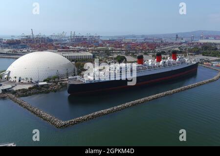 The RMS Queen Mary ocean liner cruise ship is docked with the Spruce Goose as a backdrop, Wednesday, Sept. 29, 2021, in Long Beach, Calif.= Stock Photo