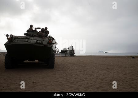 U.S. Marines with Special Marine Air-Ground Task Force – UNITAS, watch from a light armored vehicle as a landing craft, air cushion approaches Miramar beach during UNITAS LXII in Ancon, Peru, Sept. 29, 2021. UNITAS is the world’s longest-running annual multinational maritime exercise that focuses on enhancing interoperability among multiple nations and joint forces during littoral, amphibious and Amazonian operations in order to build on existing regional partnerships and create new enduring relationships that promote peace, stability and prosperity in the U.S. Southern Command’s area of respo Stock Photo