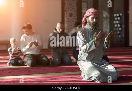 group of muslim people praying namaz  in mosque Stock Photo