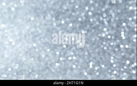 White, silver, gray Christmas background with defocused lights. Background for Valentine's Day. White or silver lights on a silver background. Stock Photo