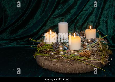 Third Advent - self made Advent wreath with selective focus on foreground with three white candles burning, a tradition in the four weeks before Chris Stock Photo