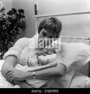 Actress Julie Andrews of 'My Fair Lady' fame pictured in the London Clinic with her new baby daughter which she will name either Emma, Kate, Sarah or Joanna. It was also announced today that Julie will make her film debut in Walt Disney's 'Mary Poppins.' 28th November 1962. Stock Photo