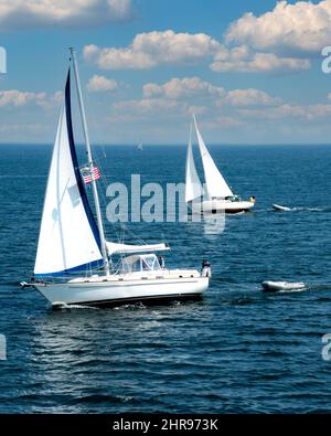 Two salis boats under sail in the Penobscot Bay jsut outside of the Rockland Breakwater Lighthouse, off Rockland, Maine Stock Photo