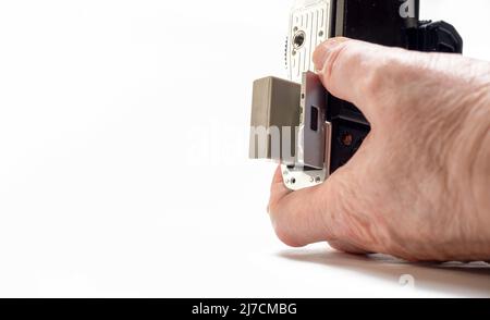 Studio Photographer changing Lithium ion battery in his DSLR camera white background  Selected Focus Stock Photo