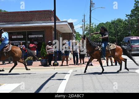 African American cowboys parade on horseback through Zebulon, NC, as part of a weekend long Juneteenth celebration of emancipation from slavery. Stock Photo