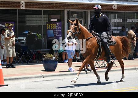 African American cowboys parade on horseback through Zebulon, NC, as part of a weekend long Juneteenth celebration of emancipation from slavery. Stock Photo