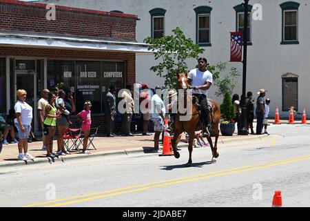 African American cowboys parade on horseback through Zebulon, NC, as part of a weekend long Juneteenth celebration of emancipation from slavery. Stock Photo