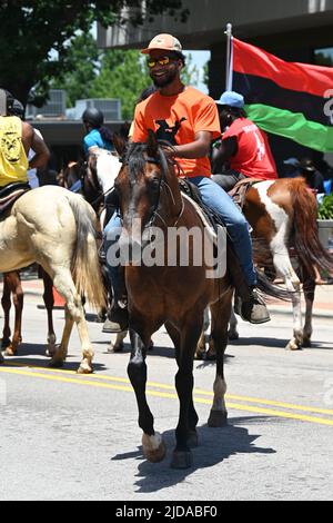 African American cowboys parade on horseback through Zebulon, NC, as part of a weekend long Juneteenth celebration of emancipation from slavery. Stock Photo