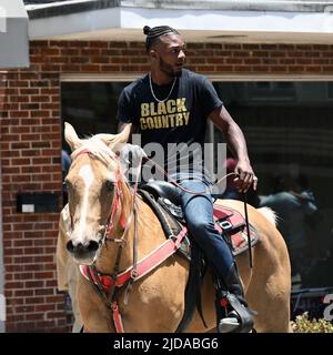 African American cowboys parade on horseback through Zebulon, NC, as part of a weekend long Juneteenth celebration of emancipation from slavery. Stock Photo