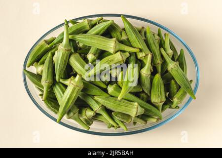 Fresh raw okra in a glass bowl. Healthy eating concept Stock Photo