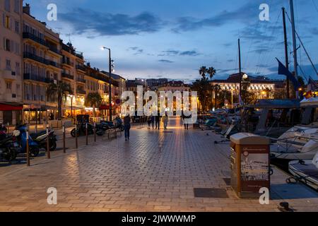 View of the marina in Cannes at night. People walking. Stock Photo