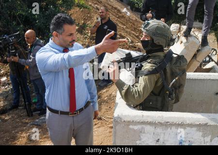 Nablus, Palestine. 26th Oct, 2022. A member from diplomatic who delegation consisting of 17 countries that recognize Palestine argues with an Israeli soldier while guarding at an Israeli checkpoint erected at the entrances to the West Bank city of Nablus to learn about the suffering of the Palestinian people at these checkpoints. Residents of the city said that these checkpoints are closed for the seventeenth consecutive day by the Israeli army. (Photo by Nasser Ishtayeh/SOPA Images/Sipa USA) Credit: Sipa USA/Alamy Live News Stock Photo