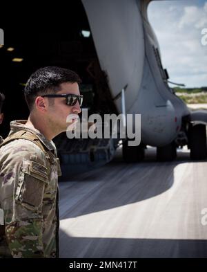 U.S. Army Soldier 1st Lt. Jamal Husien, executive officer, Alpha Company, 2nd Battalion, 27th Infantry Regiment, 3rd Infantry Brigade Combat Team, helps direct traffic on the tarmac at Andersen Air Force Base, Gaum as his unit prepares to return to Schofield Barracks, Hawaii, Sept. 28, 2022. Alpha Company deployed to Guam to rehearse their mission as the Ready Response Force, U.S. Army Pacific’s on call light infantry unit. Stock Photo