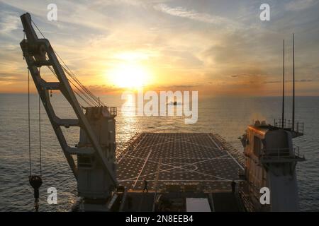 Myrtle Beach, United States of America. 10 February, 2023. A U.S. Navy Landing Craft Air Cushing approaches the Harpers Ferry-class dock landing ship USS Carter Hall as it returns at sunset during recovery operations of the Chinese high-altitude surveillance balloon in the Atlantic Ocean, February 8, 2023 off the coast of Myrtle Beach, South Carolina. The suspected spy balloon was shot down by American fighter aircraft on February 4th after traveling across the continental United States. Credit: MC3 Eric Moser/US Navy Photo/Alamy Live News Stock Photo