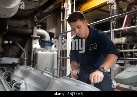 220804-N-FO865-2048    PACIFIC OCEAN (Aug 4, 2022) – Fireman Lance Dalton secures a cylinder cover on a marine diesel engine in a main machinery room aboard amphibious transport dock ship USS John P. Murtha (LPD 26), August 4. Sailors perform scheduled maintenance on shipboard equipment to prolong the ship’s life and serviceability. John P. Murtha, part of amphibious squadron (CPR) SEVEN, along with 13th Marine Expeditionary Unit (MEU), is currently underway conducting integrated training in U.S. 3rd Fleet to prepare for an upcoming deployment. Stock Photo