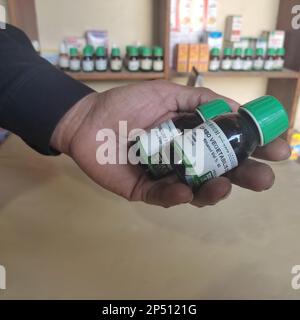 Closeup image of homeopathic medicine consisting of the pills and a bottle containing a liquid homeopathic substance Stock Photo