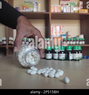 Closeup image of homeopathic medicine consisting of the pills and a bottle containing a liquid homeopathic substance Stock Photo