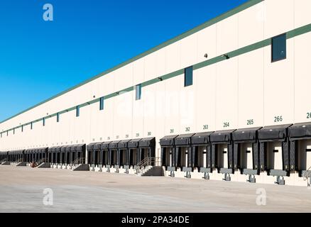 Truck loading bays at a large distribution warehouse. Stock Photo