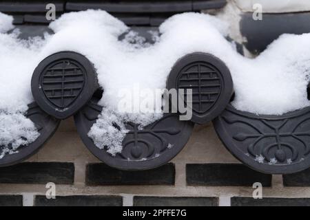 snow covered Korean traditional roof tile Stock Photo