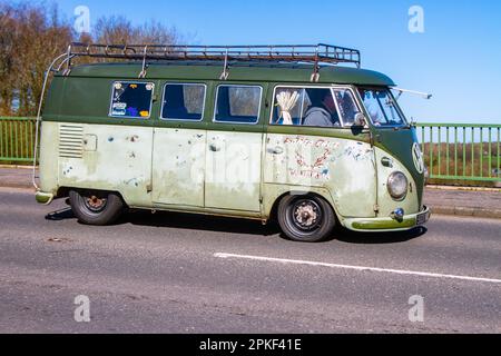 1957 50s fifties Splity, VW Volkswagen window van, original paint VW Split screen bus, original White (Blauweis) over Velvet Green paint; crossing motorway bridge in Greater Manchester, UK Stock Photo