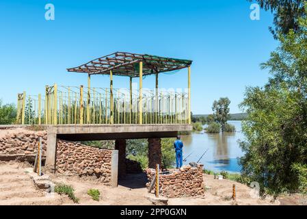 Douglas, South Africa - Mar 1, 2023: Angler at Samevloeiing near Douglas where the Orange and Vaal Rivers join Stock Photo