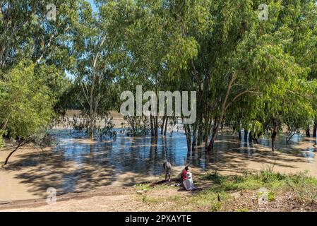 Douglas, South Africa - Mar 1, 2023: Young women fishing at Samevloeiing near Douglas where the Orange and Vaal Rivers join Stock Photo