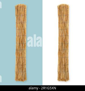 Rolled up bamboo curtain sun protection. Top view isolated on white and light blue background. Patio blind sunscreen. Stock Photo