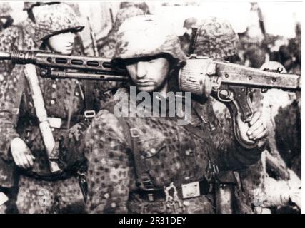 World War Two B&W photo German Troops in Dot camo Uniforms during the Ardennes Offensive 1945 . The men are members of the Leibstandarte SS Panzer Division Stock Photo