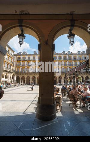 San Sebastian Plaza Constitucion, view in summer of people relaxing at cafe tables inside the Plaza de la Constitucion in San Sebastian's Old Town. Stock Photo