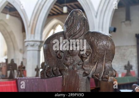 Carved poppyhead pew finial with grotesque face on oak pews in the Church of St Mary the Virgin, Ivinghoe village, Buckinghamshire, England, UK Stock Photo