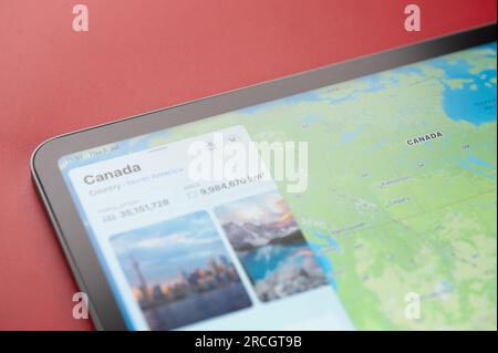 New York, USA - July 6, 2023: Canada country on world map in screen of ipad tablet close up view Stock Photo