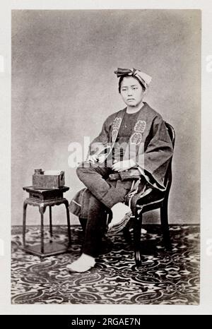 Vintage 19th century photograph - early  photographic portrait from Japan, probably the work of the Japanese photographer Shimooka Renjo - seated man Stock Photo