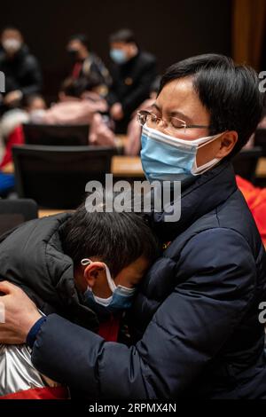 200218 -- BEIJING, Feb. 18, 2020 -- A medical team member R hugs her son before leaving for Hubei Province, in Kunming, capital of southwest China s Yunnan Province, Feb. 16, 2020. The fifth batch of 108 medical workers from Yunnan left for Hubei Province on Sunday to aid the novel coronavirus control efforts there.  XINHUA PHOTOS OF THE DAY HuxChao PUBLICATIONxNOTxINxCHN Stock Photo