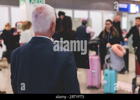 Meeting at the airport, person holding a placard card sign with welcome title text, greeting passenger on arrival, holding a name plate to greet trave Stock Photo