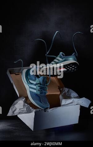 Sports Shoes photographed against a dark background with a levitation pose Stock Photo