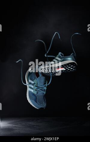 Sports Shoes photographed against a dark background with a levitation pose Stock Photo