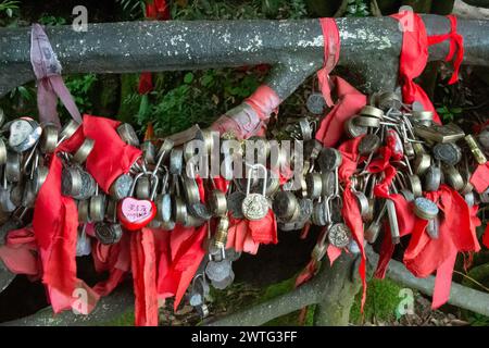 A love lock depicting Buddha hangs with many other holy padlocks in Tianmen Mountain National Park, China. Stock Photo