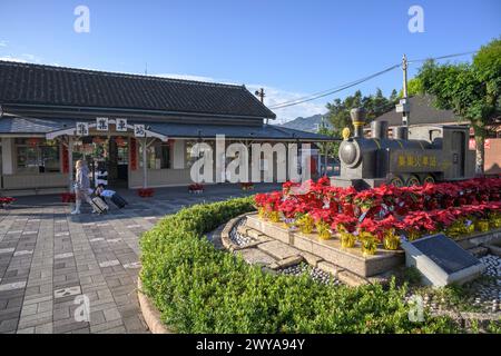 Girls walking with luggage in front of Jiji railway station Stock Photo