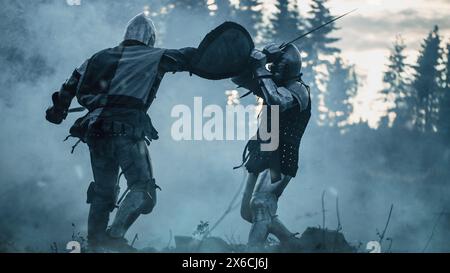 Dark Age Battlefield: Two Armored Medieval Knights Fighting with Swords. Battle of Armed Warrior Soldiers, Killing Enemy in Mysterious Forest. Cinematic Smoke, Mist, Light in Historic Reenactment Stock Photo