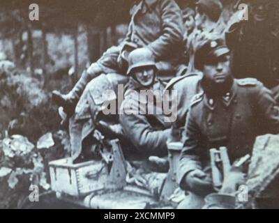 World War Two B&W Screenshot photo . German Troops of the SS Division Leibstandarte advance during the Battle of the Bulge in Belgium December 1944 Stock Photo