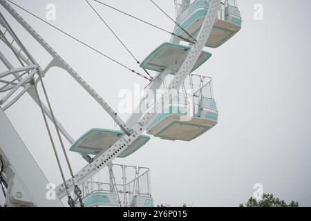 Ferris wheel cabin detail. Gray sky in background. Stock Photo