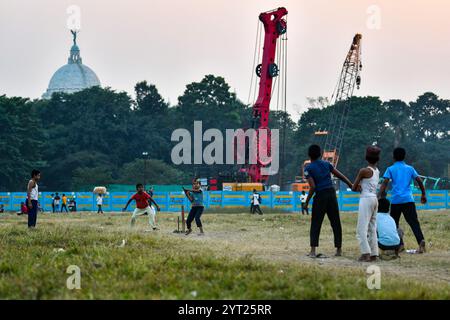 Children play in the Maidan area, an urban park whereas metro railway construction work is visible in the background. Stock Photo