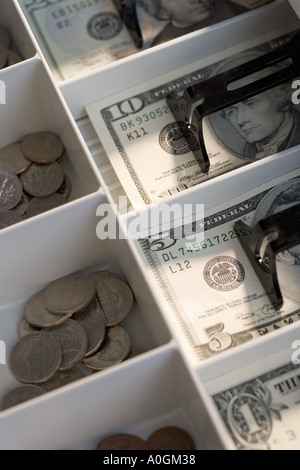 U S bills and coins in cash register Stock Photo